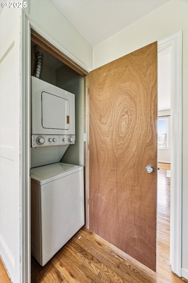 1411 N Alberta St Unit 1, Portland, OR 97035 - laundry area with estacked washer and dryer and wood finished floors