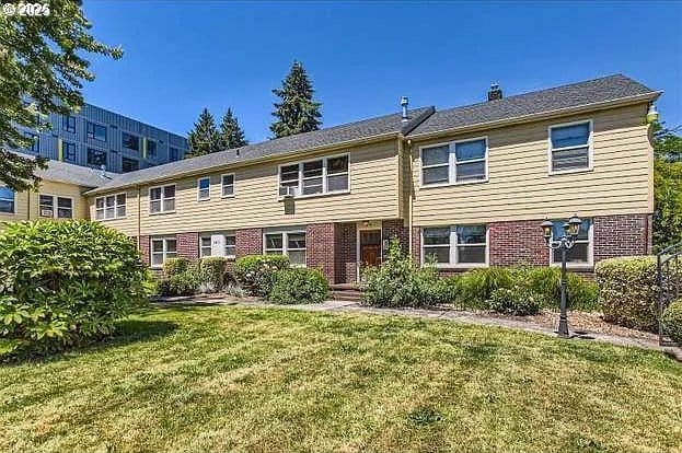 1411 N Alberta St Unit 1, Portland, OR 97035 - view of front of house featuring a front yard, brick siding, and a chimney