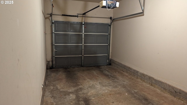 garage with baseboards and a garage door opener