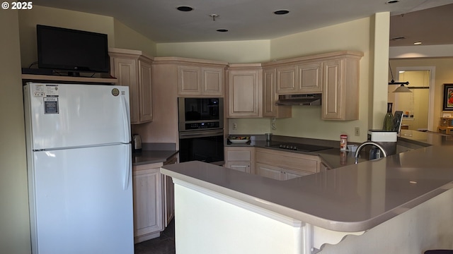 kitchen with built in microwave, freestanding refrigerator, a peninsula, black electric stovetop, and stainless steel oven