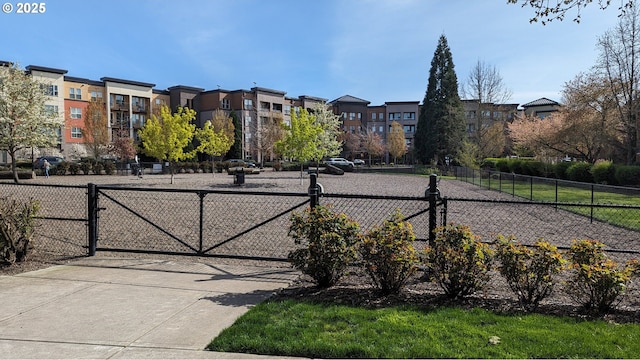 view of home's community featuring a gate and fence