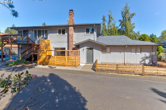 6097 SW Valley Ave, Beaverton, OR 97008 - view of front of home with a deck, stairway, and a chimney