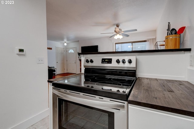 6097 SW Valley Ave, Beaverton, OR 97008 - kitchen with stainless steel electric range oven, a ceiling fan, dark countertops, and baseboards
