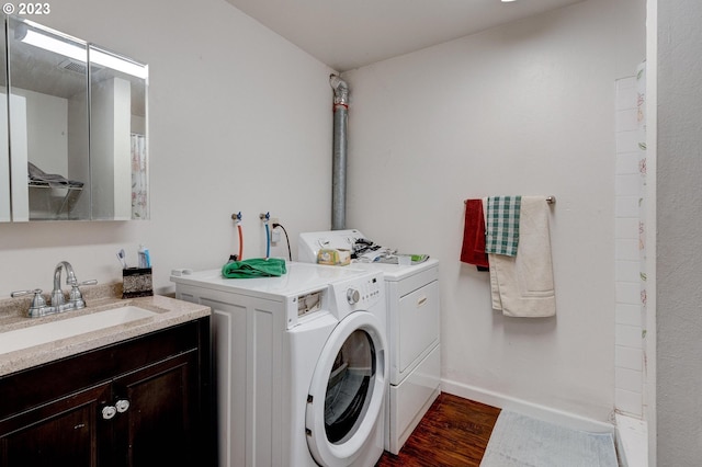 6097 SW Valley Ave, Beaverton, OR 97008 - washroom with washer and dryer, a sink, dark wood finished floors, and baseboards