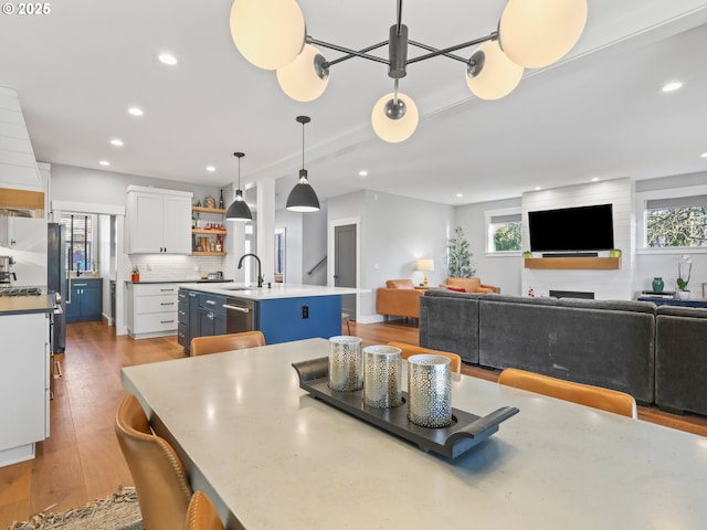 dining area featuring sink and light hardwood / wood-style flooring