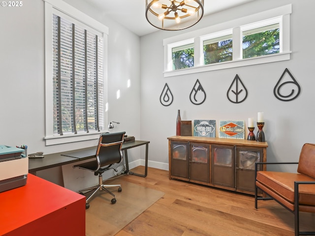 office area featuring an inviting chandelier and light hardwood / wood-style flooring