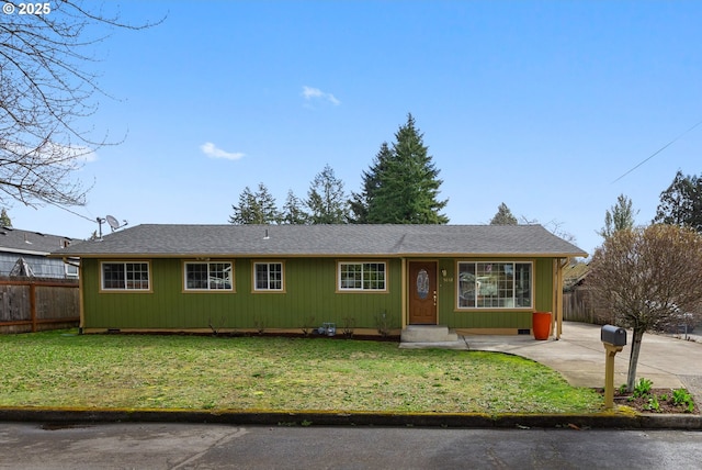 ranch-style house featuring a front yard and fence