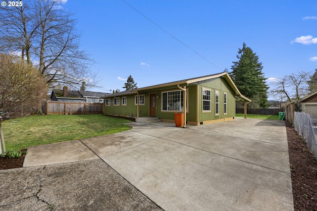 view of front facade with a front lawn, fence private yard, and crawl space