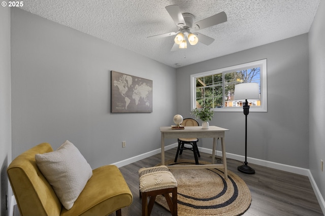 office space featuring a textured ceiling, wood finished floors, baseboards, and ceiling fan