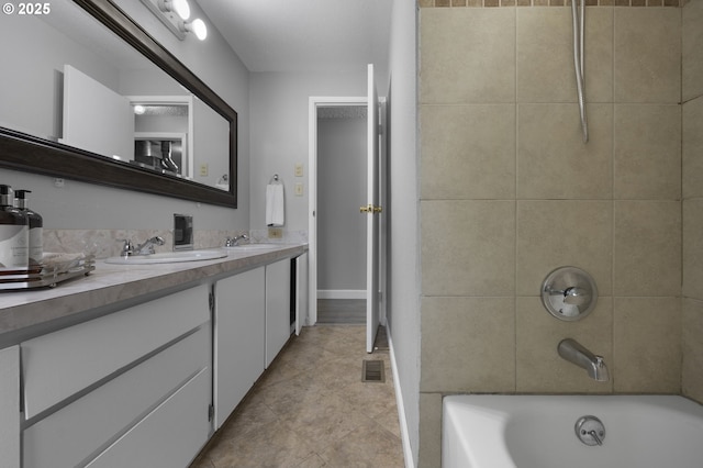 bathroom with double vanity, visible vents,  shower combination, and a sink