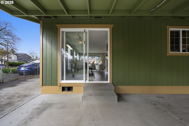 doorway to property featuring a patio area and fence