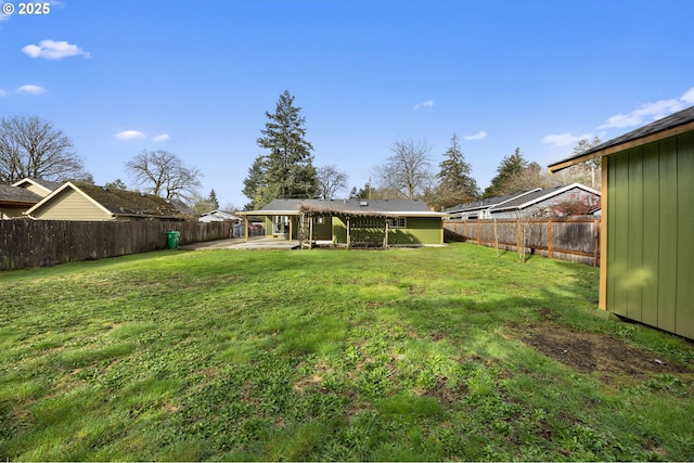 view of yard with a patio area and a fenced backyard