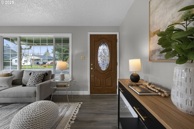 entrance foyer featuring dark wood finished floors, baseboards, and a textured ceiling