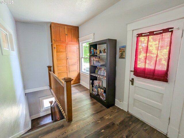 entryway featuring dark wood-style floors and baseboards
