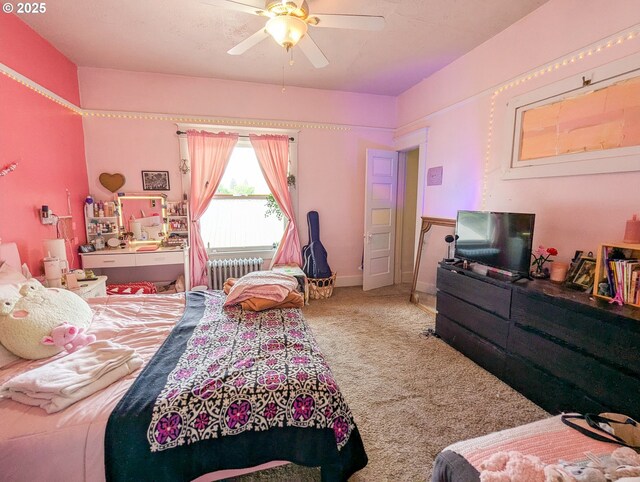bedroom featuring radiator heating unit, carpet, and a ceiling fan