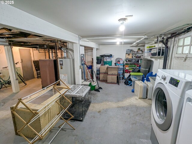 unfinished below grade area with gas water heater and washing machine and dryer