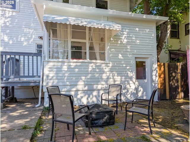 view of patio / terrace featuring a fire pit and fence