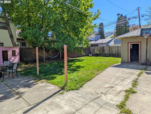 view of yard with a patio area and an outbuilding