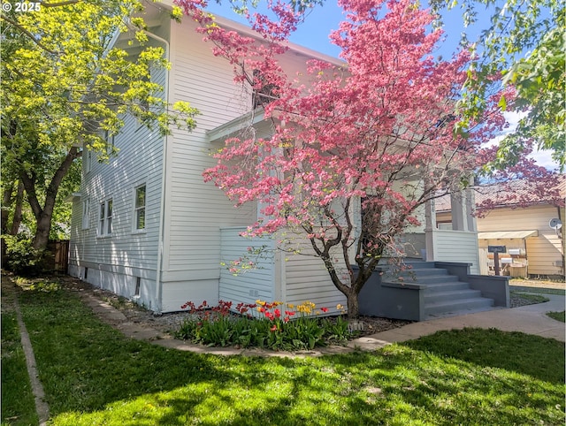 view of side of home featuring a lawn