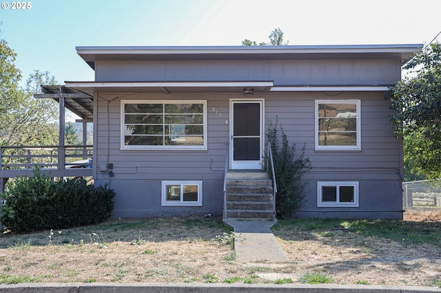 view of front of house with entry steps and fence