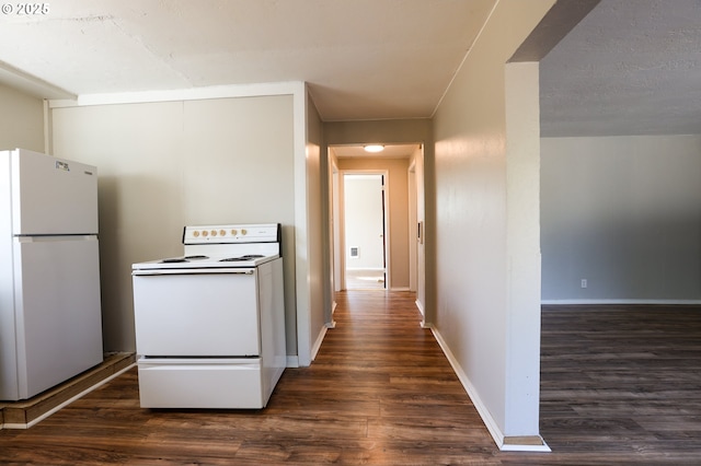 kitchen featuring white appliances, baseboards, and dark wood-type flooring