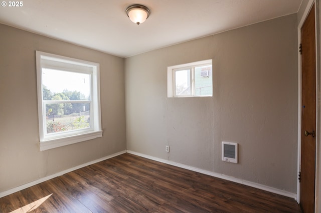 unfurnished room with dark wood-style flooring and baseboards