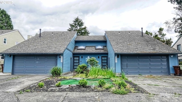 view of front of home featuring a shingled roof, a garage, and driveway