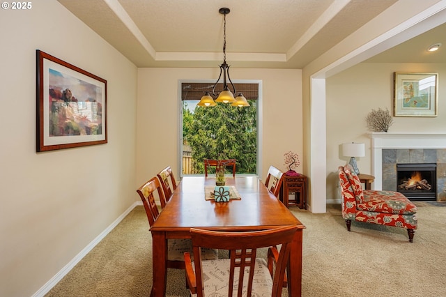 1761 S 18th Cir, Ridgefield, WA 98642 - carpeted dining room with a tray ceiling, a fireplace, and a chandelier
