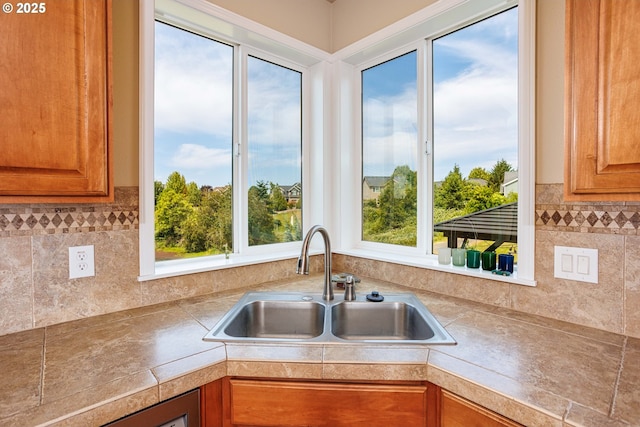 1761 S 18th Cir, Ridgefield, WA 98642 - kitchen with brown cabinets, plenty of natural light, decorative backsplash, and tile counters
