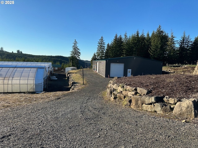 view of property exterior with a garage and an outdoor structure