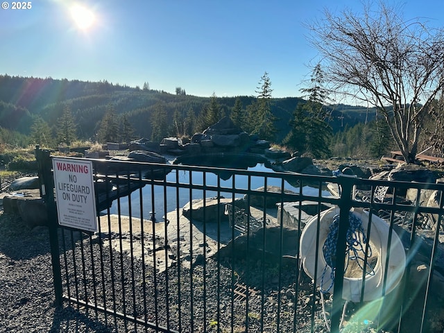 view of gate with a water view