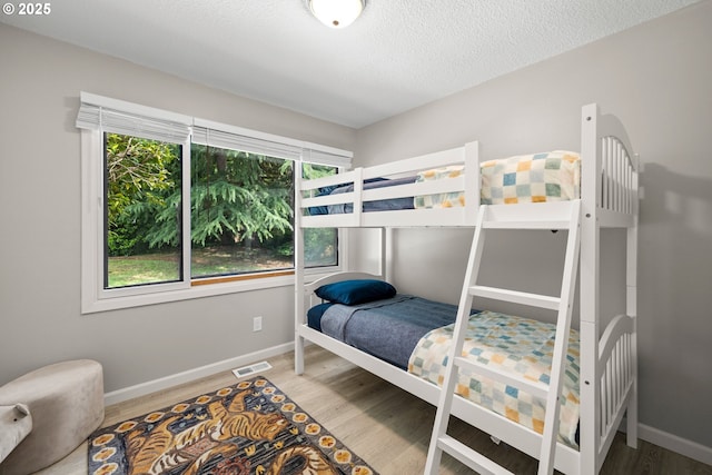6401 Mcewan Rd, Lake Oswego, OR 97035 - bedroom with wood finished floors, baseboards, and a textured ceiling