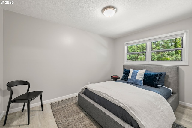 6401 Mcewan Rd, Lake Oswego, OR 97035 - bedroom featuring wood finished floors, baseboards, and a textured ceiling