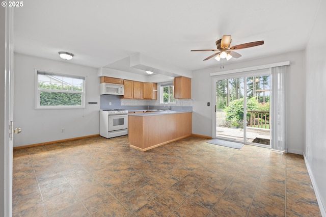 15182 Henrici Rd, Oregon City, OR 97045 - kitchen with white appliances, plenty of natural light, a peninsula, and light countertops