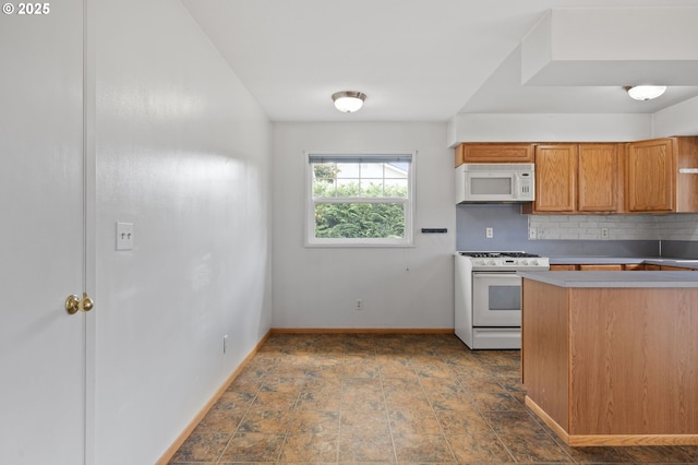 15182 Henrici Rd, Oregon City, OR 97045 - kitchen featuring white appliances, tasteful backsplash, brown cabinets, light countertops, and dark stone finish floors