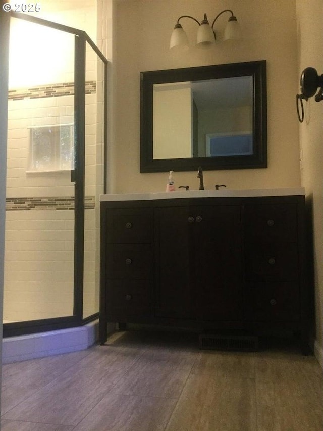 4247 Redwood Hwy, Grants Pass, OR 97527 - full bathroom featuring a stall shower, vanity, and wood finished floors