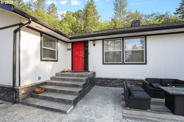 4247 Redwood Hwy, Grants Pass, OR 97527 - view of exterior entry with a chimney, an outdoor living space, and a patio area