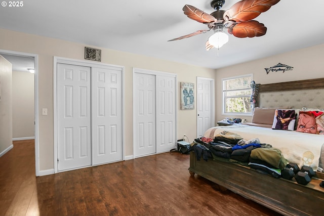 4247 Redwood Hwy, Grants Pass, OR 97527 - bedroom featuring two closets, wood finished floors, baseboards, and a ceiling fan