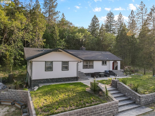 4247 Redwood Hwy, Grants Pass, OR 97527 - view of front facade with a chimney, entry steps, a front lawn, and roof with shingles