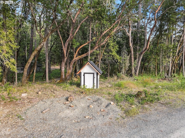 4247 Redwood Hwy, Grants Pass, OR 97527 - view of shed with a wooded view