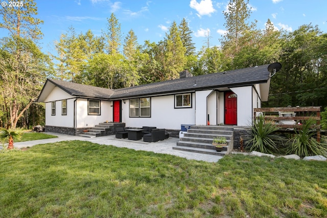 4247 Redwood Hwy, Grants Pass, OR 97527 - back of property with an outdoor living space, a lawn, a chimney, entry steps, and a patio