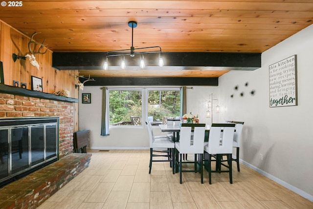 4247 Redwood Hwy, Grants Pass, OR 97527 - dining area featuring wood ceiling with exposed beams, baseboards, a fireplace, and wood finished floors