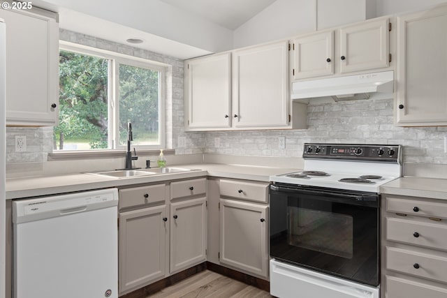 86336 N Modesto Dr, Eugene, OR 97402 - kitchen with white appliances, under cabinet range hood, light countertops, backsplash, and light wood finished floors