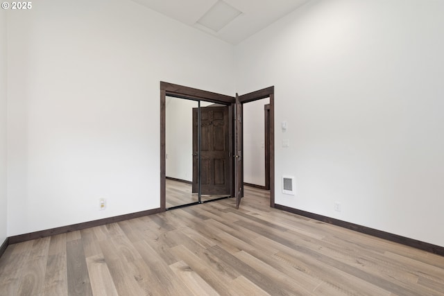 86336 N Modesto Dr, Eugene, OR 97402 - unfurnished room featuring light wood-style flooring, attic access, and a towering ceiling