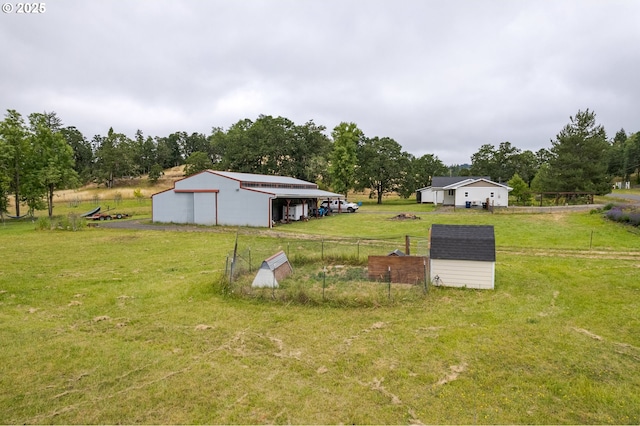 86336 N Modesto Dr, Eugene, OR 97402 - view of yard featuring an outdoor structure, an outbuilding, a detached garage, and view of wooded area