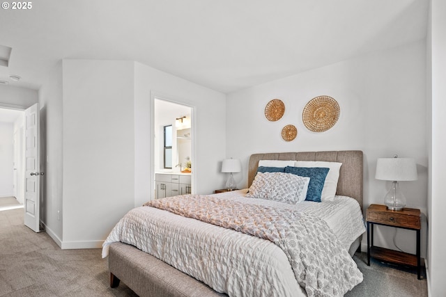 bedroom with light carpet and ensuite bath