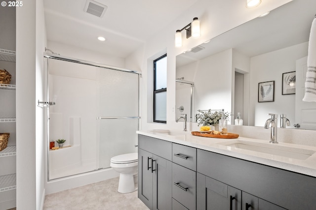 bathroom featuring an enclosed shower, vanity, and toilet