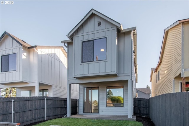 rear view of property with a yard