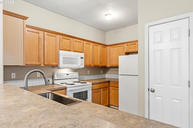 kitchen featuring sink and white appliances