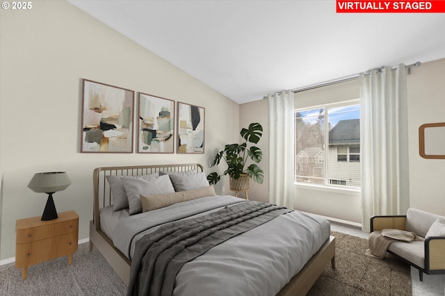 carpeted bedroom featuring vaulted ceiling